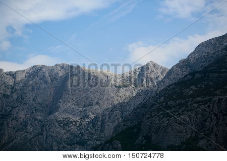 Beautiful mountain ranges with high peaks natural elevation of earth surface on blue sky background