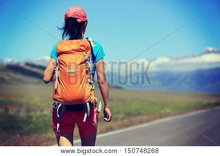 young woman hiker hiking at beautiful mountain trail
