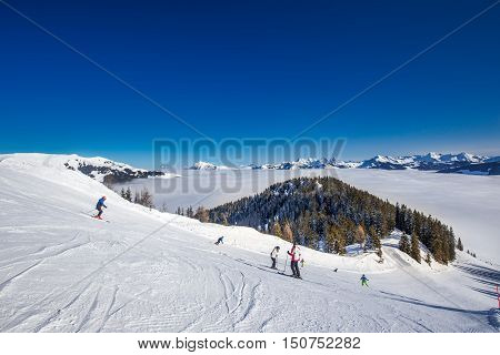 Kitzbuehel, Austria - February 18, 2016 - Skier Skiing And Enjoying The View To Alpine Mountains In