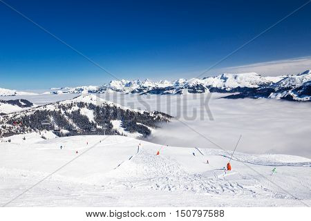 View to Alpine mountains and ski slopes in Austria from famous Kitzbuehel ski resort with 54 cable cars 170 km prepared skiing slopes and place of famous Hahnenkamm races.