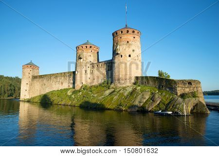 The old Olavinlinna fortress in the rays of the setting sun on august evening. Savonlinna, Finland