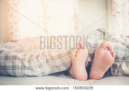 Close Up Feet Of Women Sleeping  On Bed In Morning