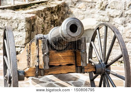 Close up photo of historic cannon. Retro object. Military theme.