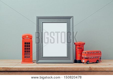 Poster mock up template with London telephone booth and red bus. Travel and tourism concept.