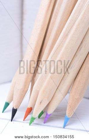 Group of sharp wooden crayons closeup in box