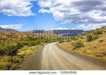 Desert landscape with the cloudy sky in Karoo National Park, Western Cape province of South Africa. The parks of South Africa are famous for the magnificent scenery and wildlife.