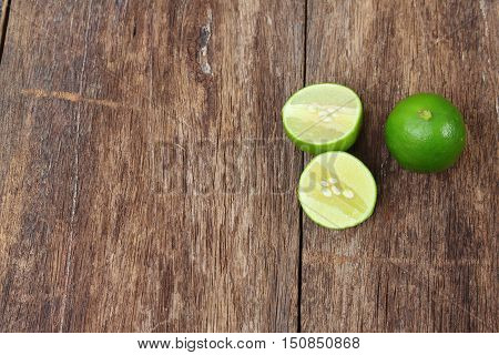 lemon fresh green and slice lime on wooden table top view