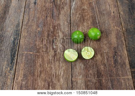 lemon fresh green and slice lime on wooden table top view