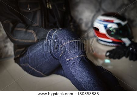 Biker man wearing jeans and leather jecket with helmet and glove