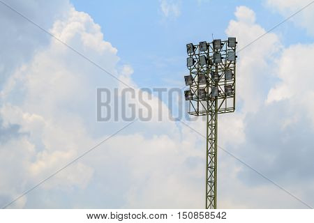 Sport stadium floodlights on a cloudy background. Soccer stadium lighting.