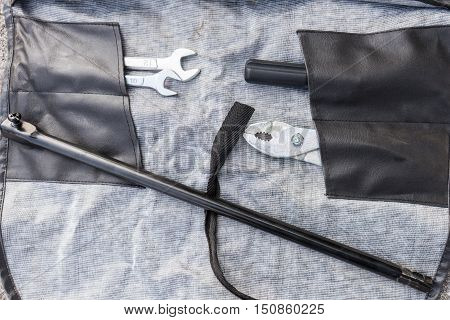 Top view of unfold black leather bag of toolkit for general fixing