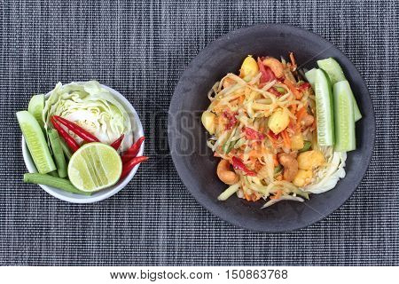 Spicy papaya salad with mixed vegetable call "Som Tum J" is organic food served.