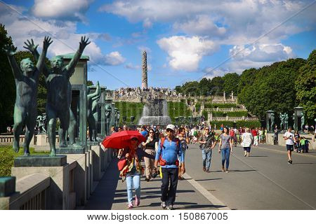EDITORIAL OSLO NORWAY - AUGUST 18 2016: Many tourist walk Vigeland Sculptures Park in the popular Vigeland park ( Frogner Park ) designed by Gustav Vigeland in Oslo Norway on August 18 2016.