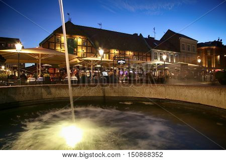 MALMO SWEDEN - AUGUST 16 2016: View of beautiful night scene and fountain on the market place Lilla Torg in Malmo Sweden on August 16 2016.