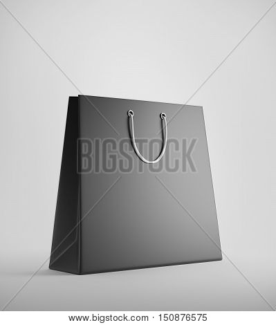 Black shopping bag standing against white background. Concept of consumerism. 3d rendering. Mockup