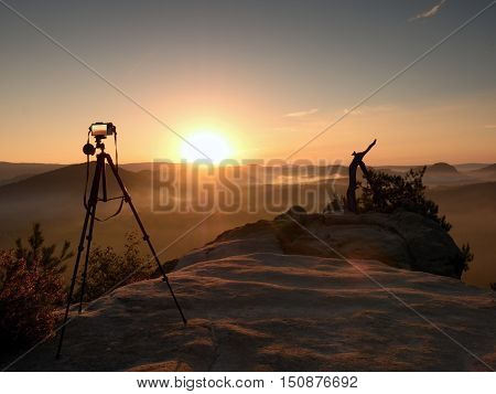 Tripod With Running Camera On  Peak Ready For Photography. Sharp Rocky Peaks
