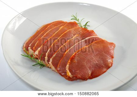 raw pork chops on a white plate