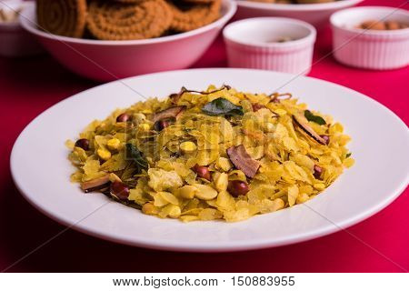 homemade tasty Diwali food or Diwali snacks or Diwali sweets like rava laddu, chakli, sev, shankar pale and chivda or chiwada with dry fruits in white bowls, favourite indian diwali recipe