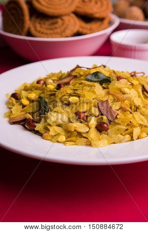 homemade tasty Diwali food or Diwali snacks or Diwali sweets like rava laddu, chakli, sev, shankar pale and chivda or chiwada with dry fruits in white bowls, favourite indian diwali recipe