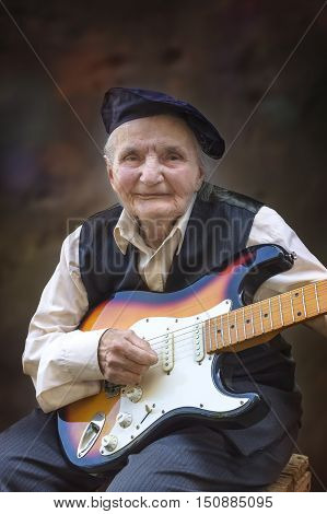 Elderly woman playing a guitar. Selective focus.