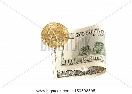 Golden bitcoin coin and one hundred dollar banknote isolated on white