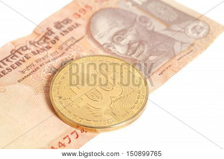 Golden bitcoin coin on Indian Ten Rupee isolated on white