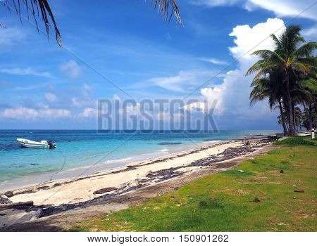 Sally Peachie Beach Big Corn Island Nicaragua Central America with fishing panga boat in Caribbean Sea