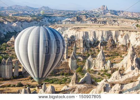 Color image of a hot air balloon flying in Cappadocia Turkey at sunrise.