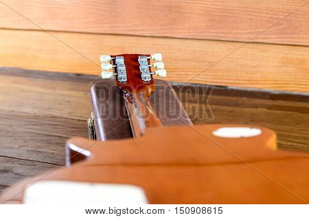 Electric Guitar and case in wood room