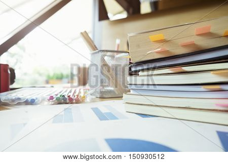 Books With Post-it Bookmarks On Working Table.