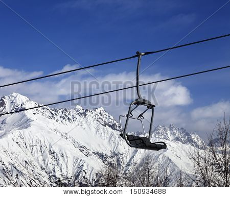 Ski lift in snow winter mountains at nice sunny day. Caucasus Mountains. Hatsvali Svaneti region of Georgia.