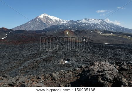 Volcanic landscape of Kamchatka: summer view of cone of Ostry Tolbachik Volcano and cone of active Plosky Tolbachik Volcano on sunny day. Eurasia Russian Far East Kamchatka Peninsula Klyuchevskaya Group of Volcanoes.