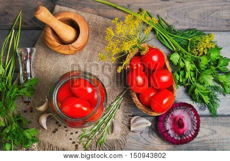 Canning pickling Preserving tomatoes herbs for canning pickling rosemary dill parsley pepper onion. Fresh vegetables for Preserving tomatoes gray wooden background. Top view.