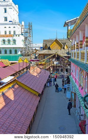 MOSCOW RUSSIA - MAY 10 2015: The covered stalls of Vernissage Market in Izmailovo with the timbered building of art workshop in front on May 10 in Moscow.