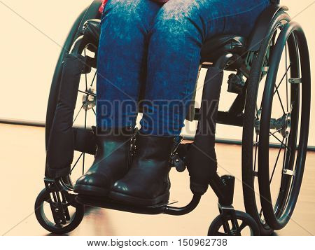 Disease disability paralysis handicap health concept. Legs of disabled person. Crippled female sitting on wheelchair.