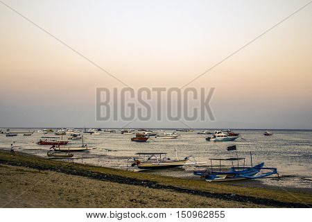 Bali in Indonesia boats harbor at Sanur Beach sunset