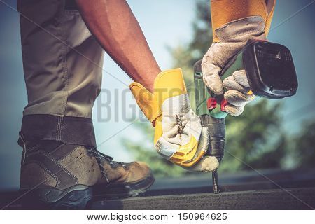 Small Residential Remodeling Works Closeup Photo. Construction Worker with Driller in Hands.
