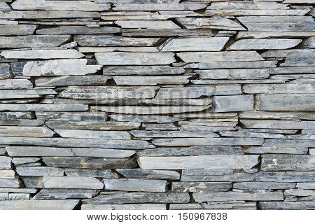 Layer of stone plate arranged as a wall / Stone wall background