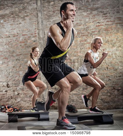 step group training, smiling people doing exercise