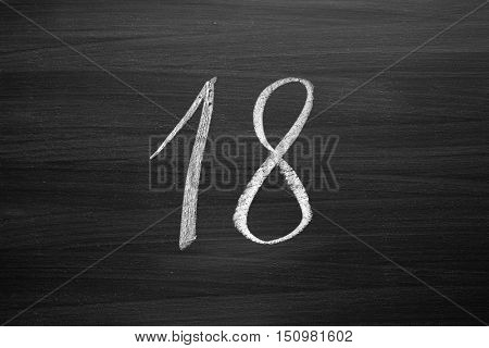 number eighteen enumeration written with a chalk on the blackboard