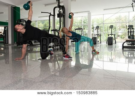 Man And Woman Kettle Bell Exercise