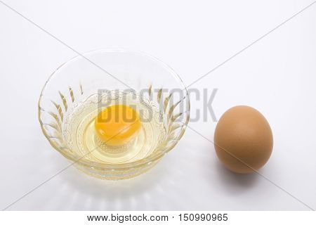 Raw Egg with Eggshell on White Background
