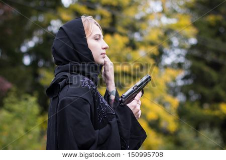 Muslim Woman With Arms In Autumn Day