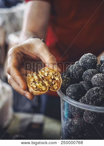 Cropped Shot Of Man Holding Halved Alani On Market At Armenia