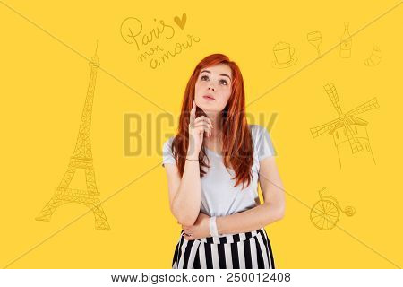 Dreaming About Paris. Beautiful Young Girl Thoughtfully Touching Her Chin While Standing Alone And D