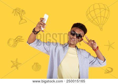 Selfie Time. Positive Boy Relaxing At The Seaside And Smiling While Taking A Selfie With A Help Of H