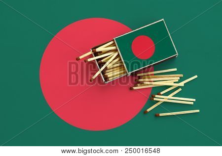 Bangladesh Flag  Is Shown On An Open Matchbox, From Which Several Matches Fall And Lies On A Large F