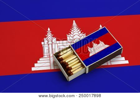 Cambodia Flag  Is Shown In An Open Matchbox, Which Is Filled With Matches And Lies On A Large Flag.