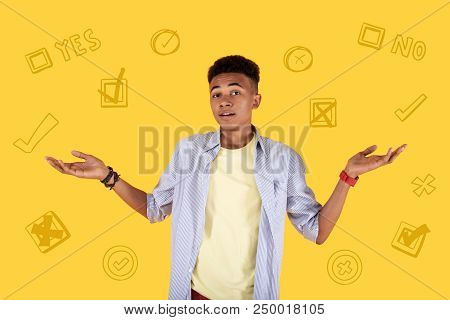 Yes Or No. Serious Teenager Putting His Hands Up While Thinking About His Future And Making An Impor