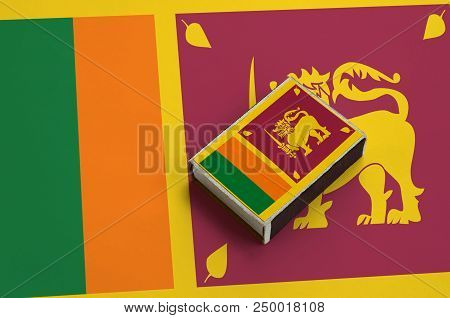 Sri Lanka Flag  Is Pictured On A Matchbox That Lies On A Large Flag.